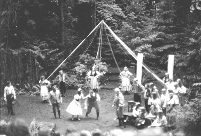 Dancing around the May pole.